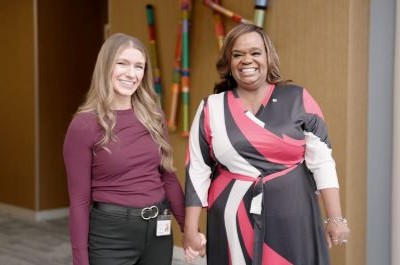 Two women holding hands and smiling