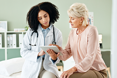 Doctor with patient in exam room